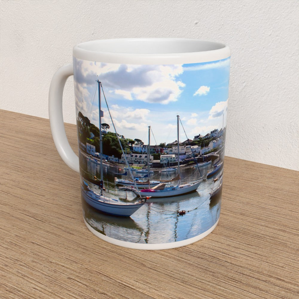 Mug with a scenic design of boats on water and sky.