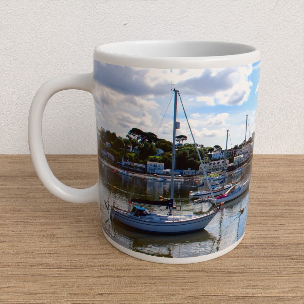 Mug with a scenic print of a harbor on a wooden surface