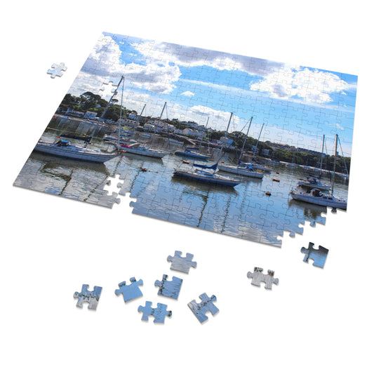 Jigsaw puzzle of a marina scene with boats and a blue sky.