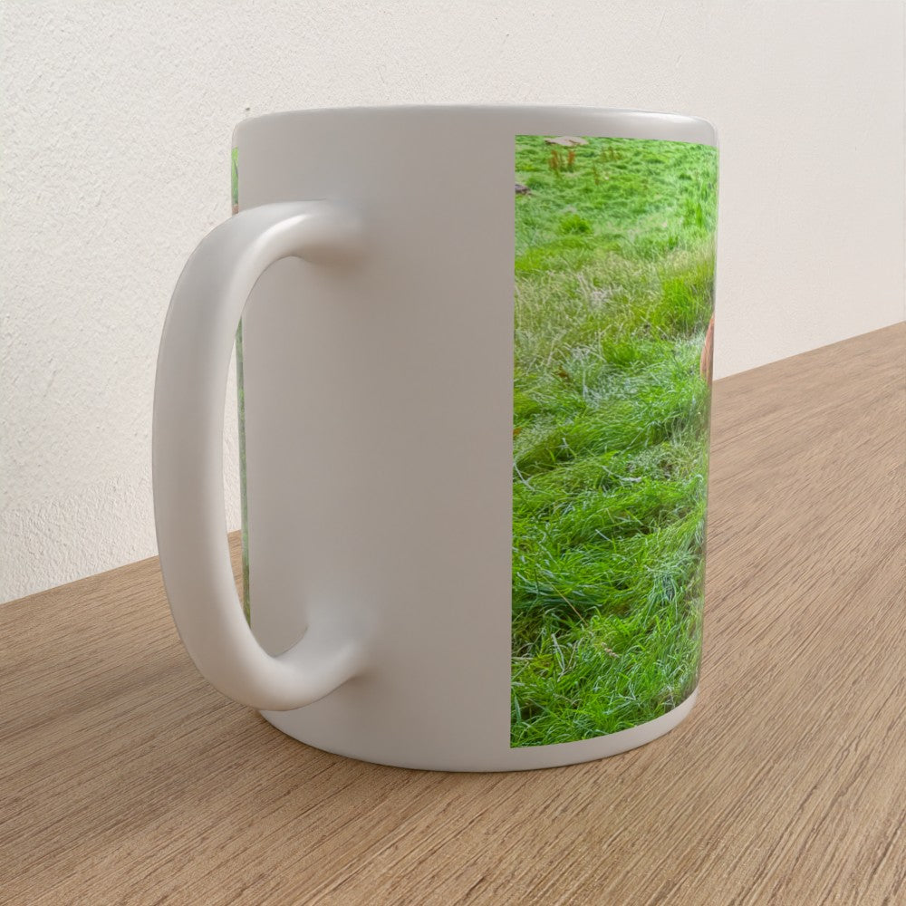 White mug with grass pattern on a wooden surface