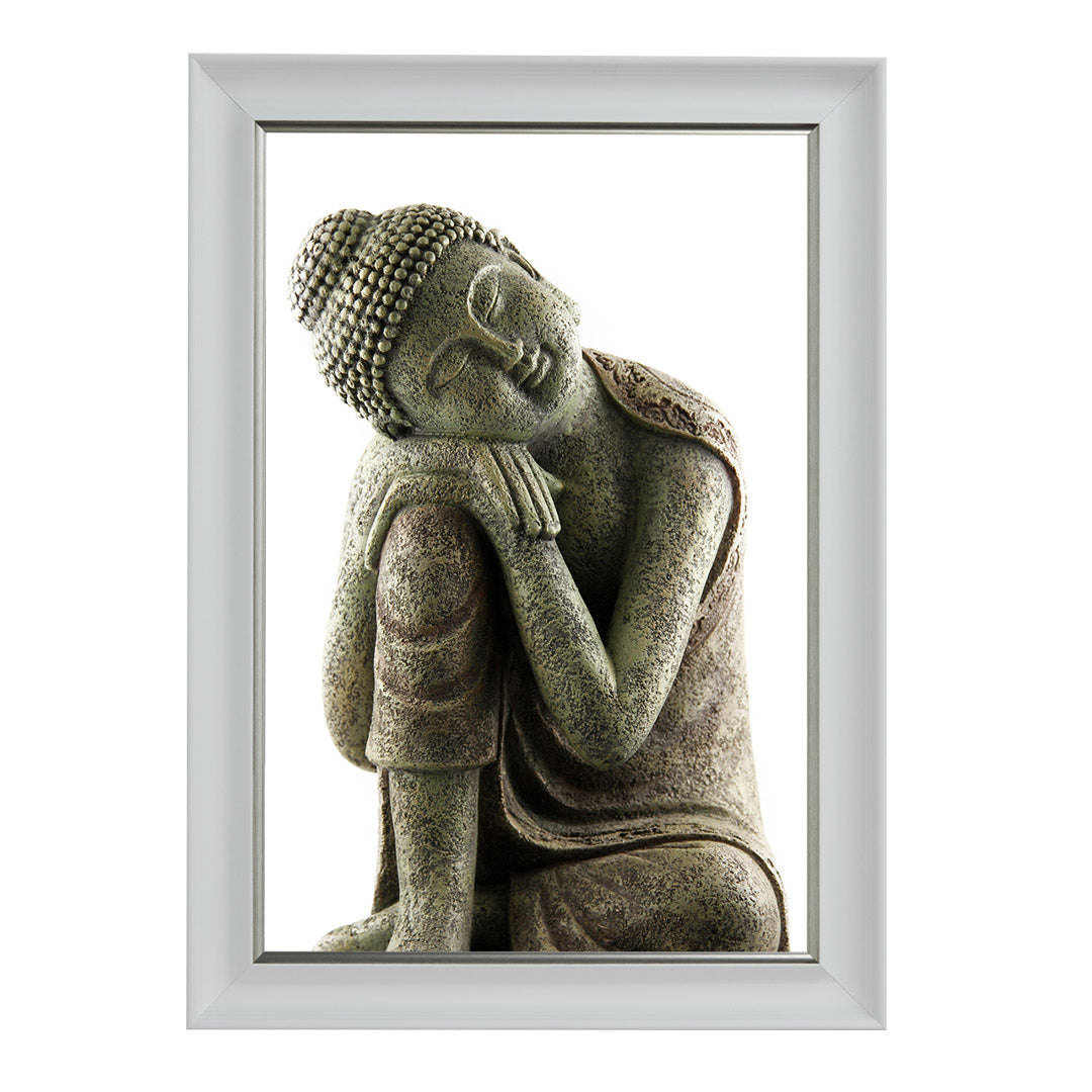 A white framed picture depicting a sculpture of a sleeping Buddha.