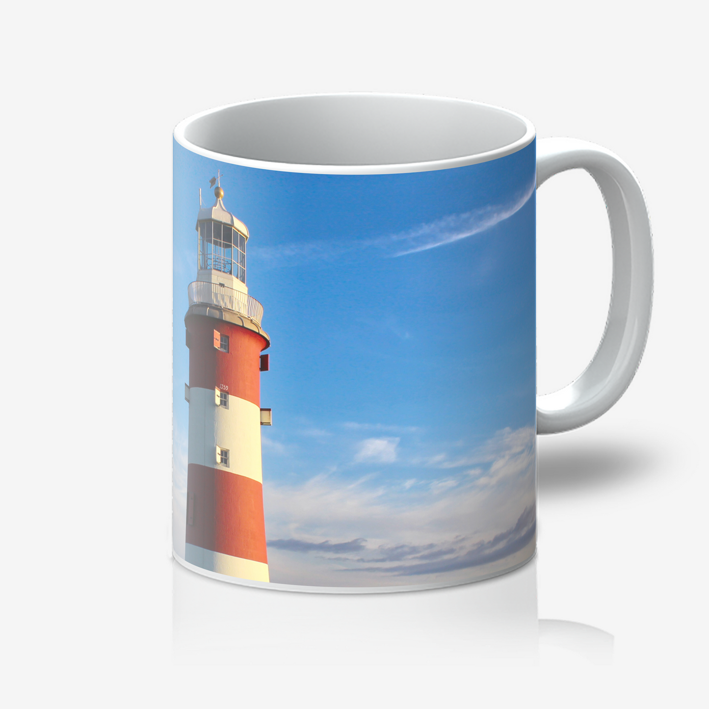Mug with a lighthouse design on a blue sky background