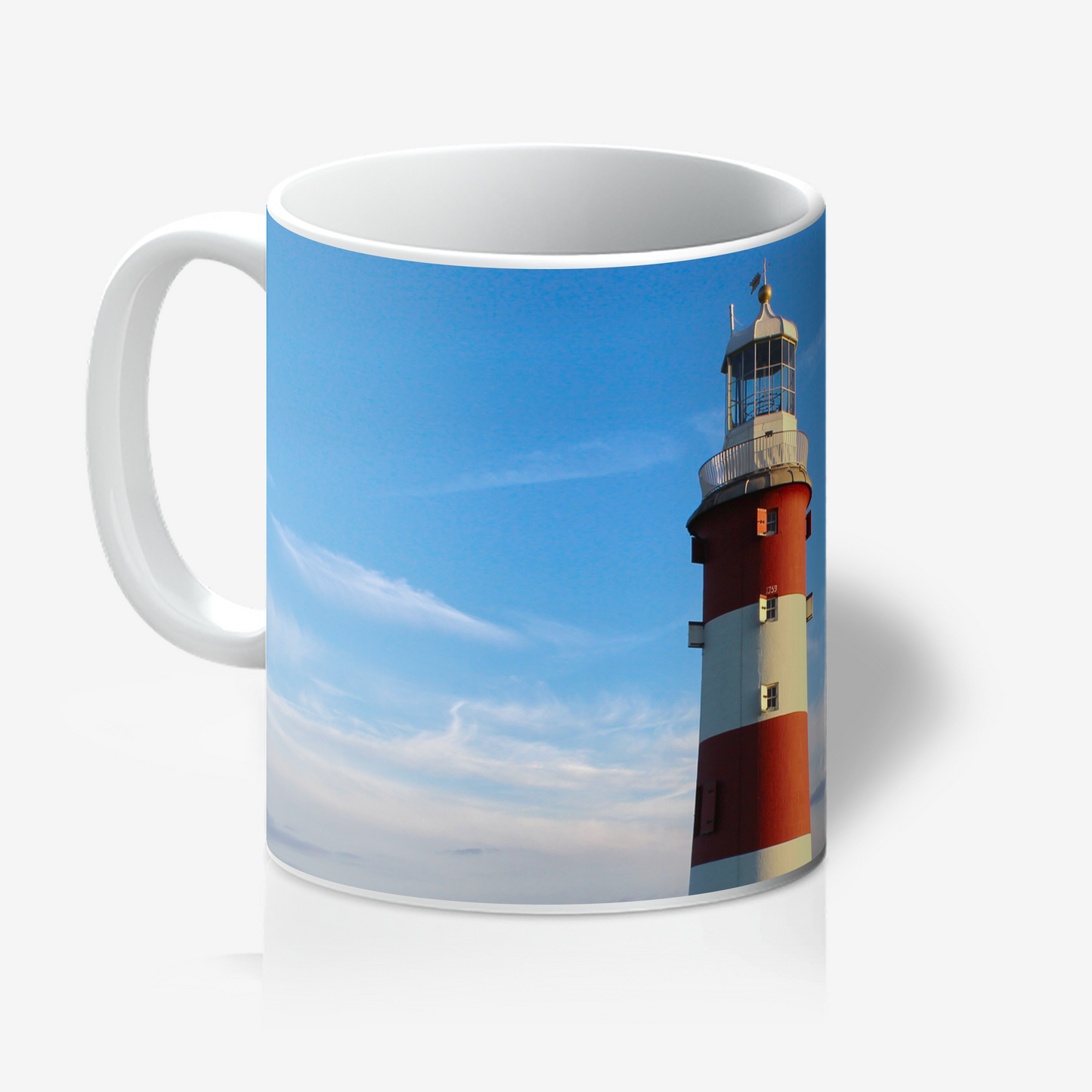 Mug with a lighthouse design on a blue sky background