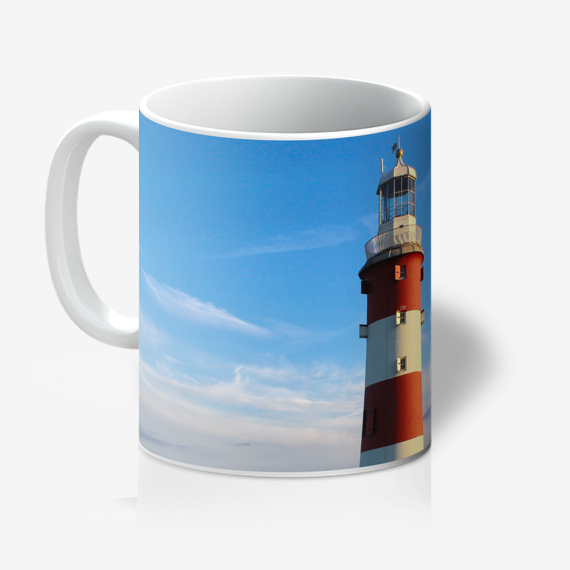 Mug with a lighthouse design on a blue sky background