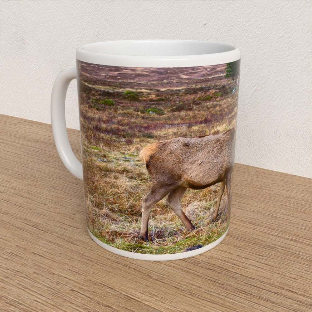 Mug with a deer design on a wooden surface