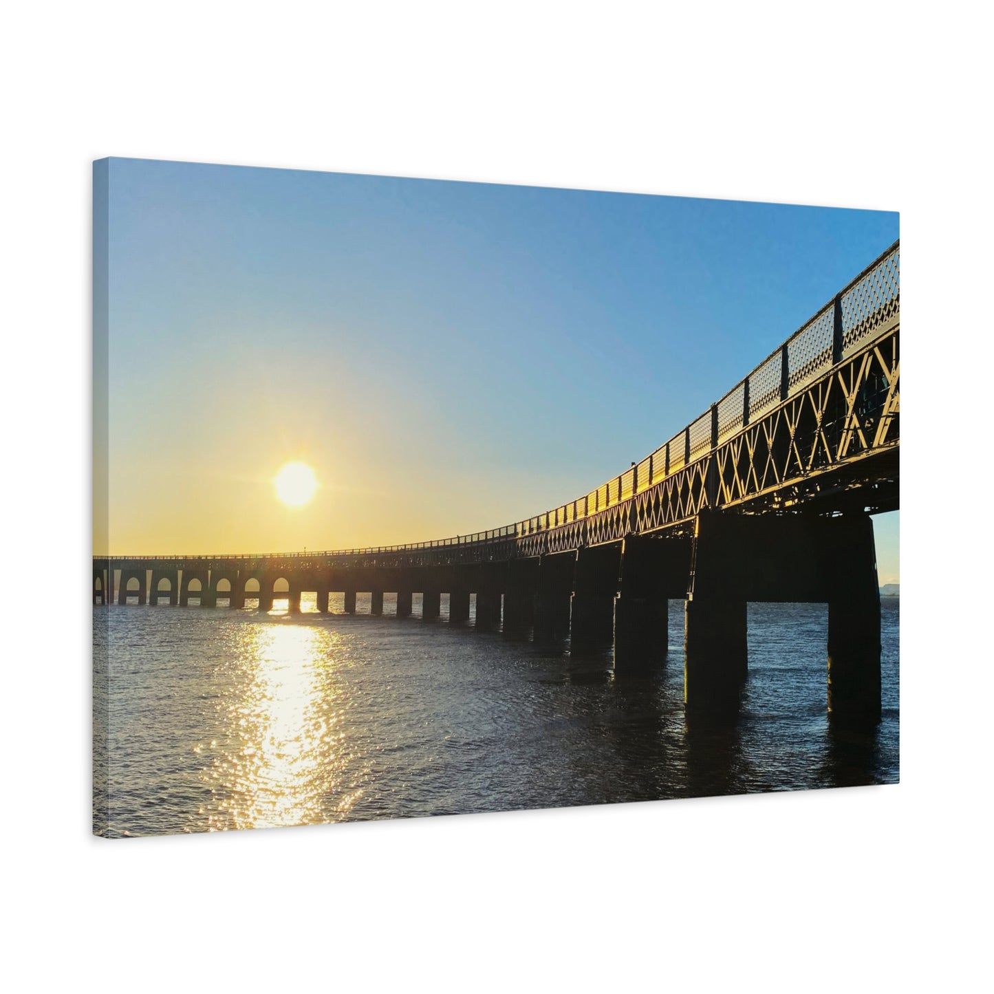Sunset over a bridge with water reflection