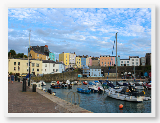 Framed Photo of a Harbour scene with colourful buildings and boats under a blue sky