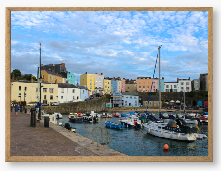 Framed Photo of a Harbour scene with colourful buildings and boats under a blue sky