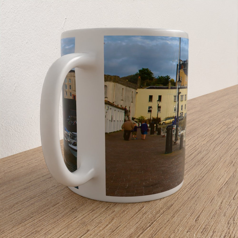 White mug with a printed design of a street scene on a wooden surface.