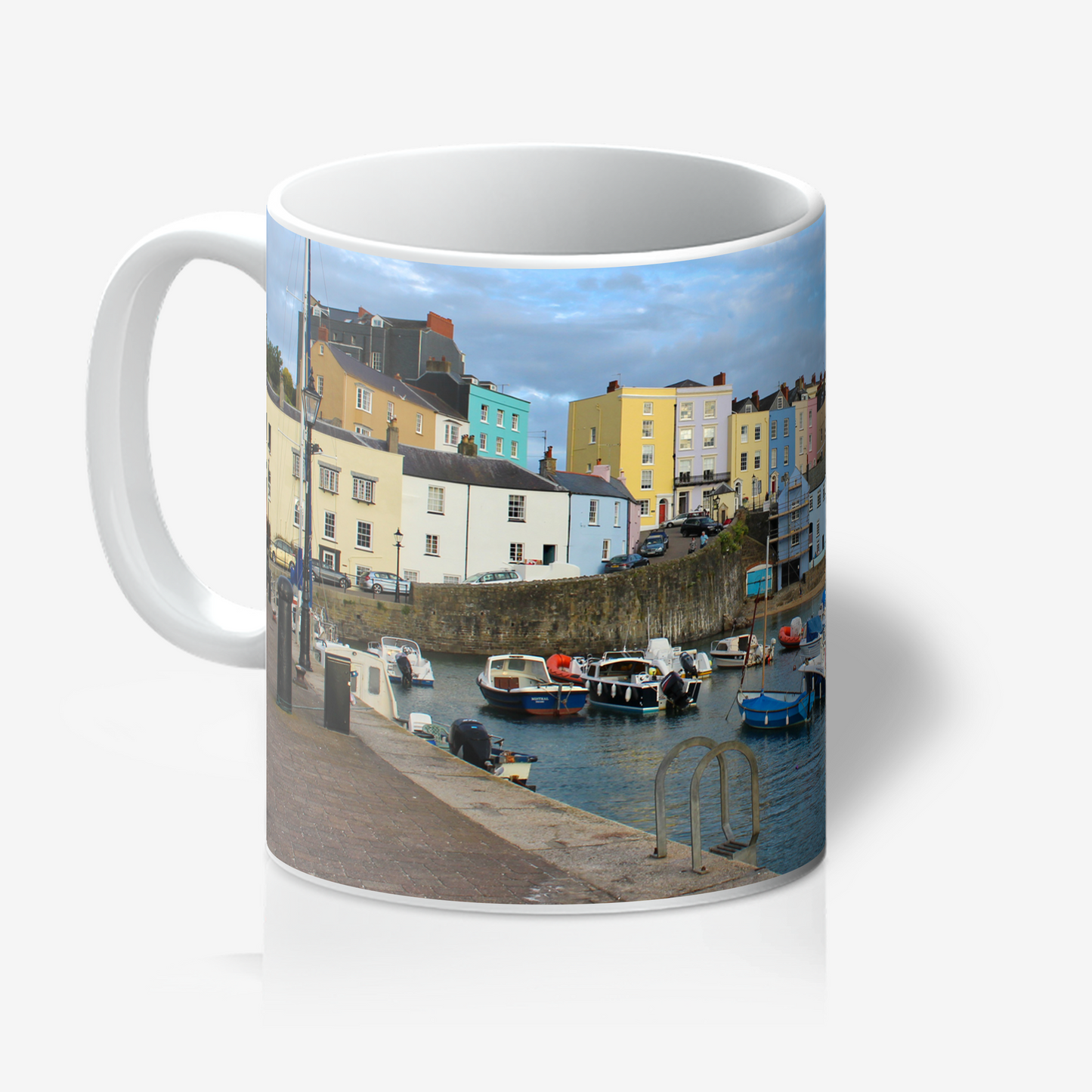 Mug with a scenic design of colourful houses and a harbour.