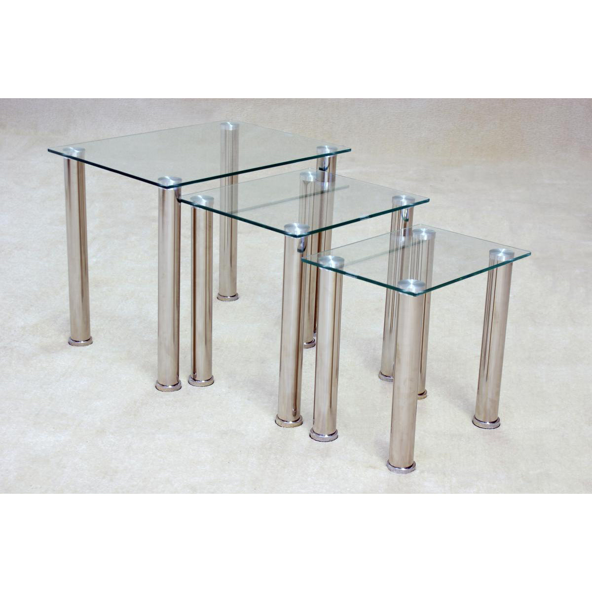 Nest of three tables with clear glass tops and chrome stainless steel table legs