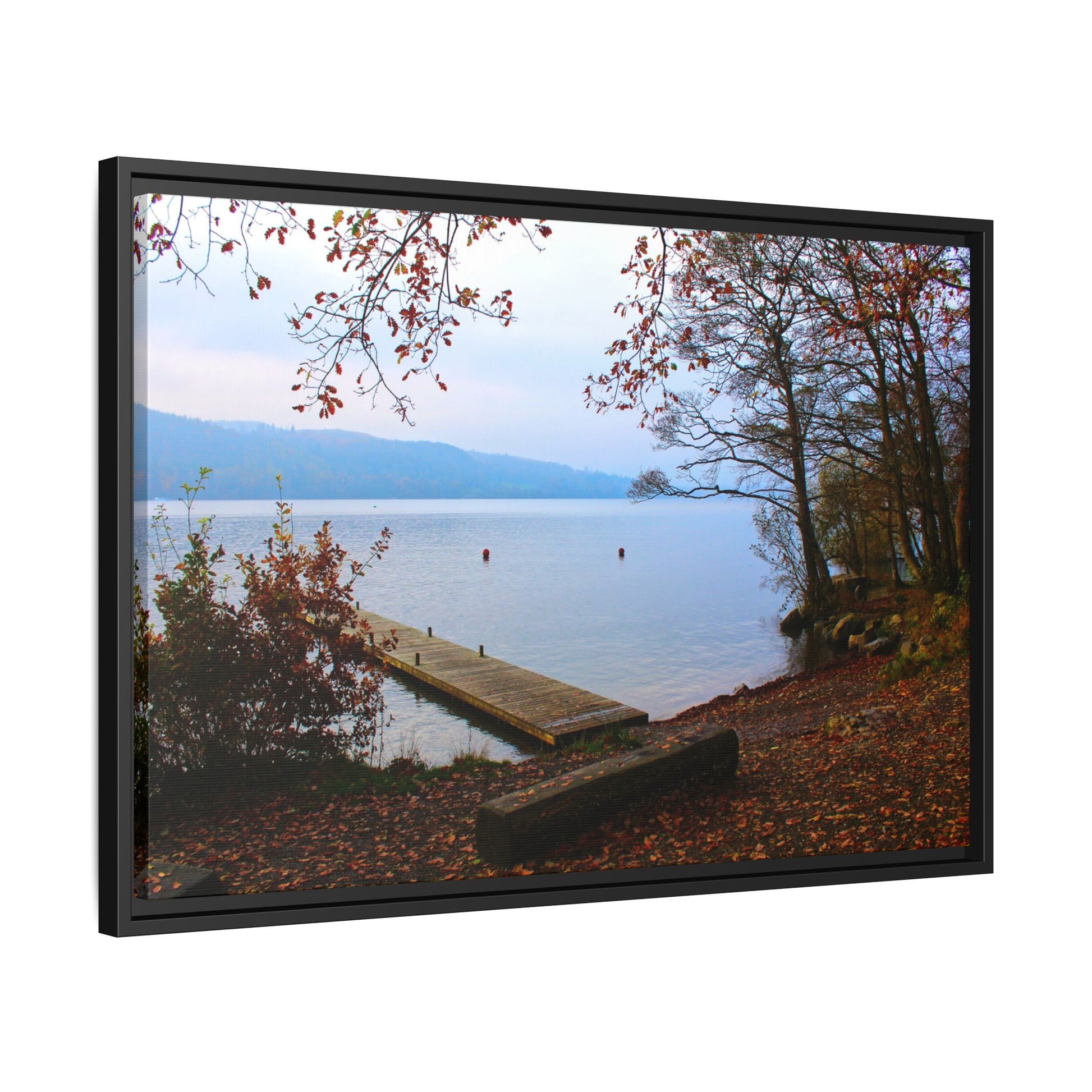 Framed picture of a lake with a dock and autumn foliage.