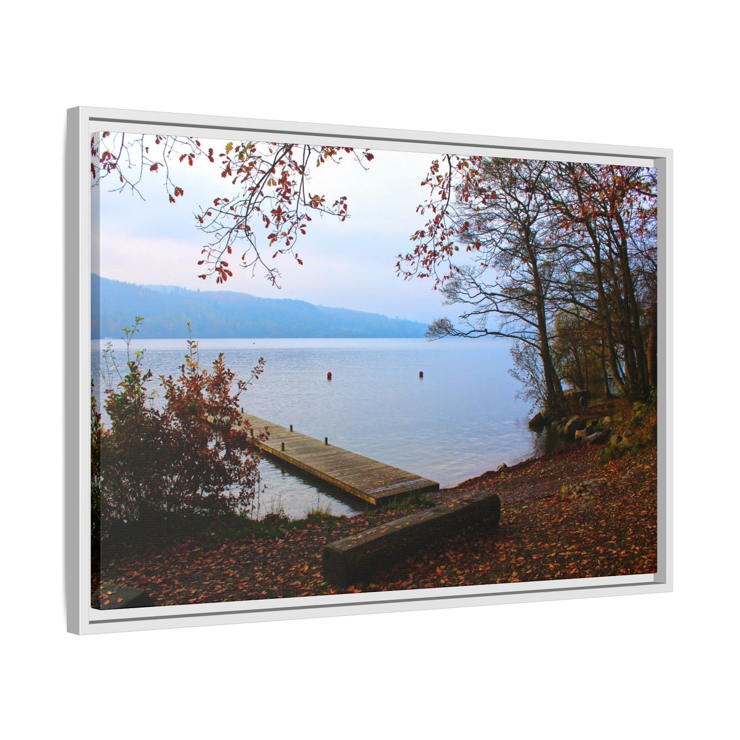 Framed picture of a lake with a dock and trees on a white background