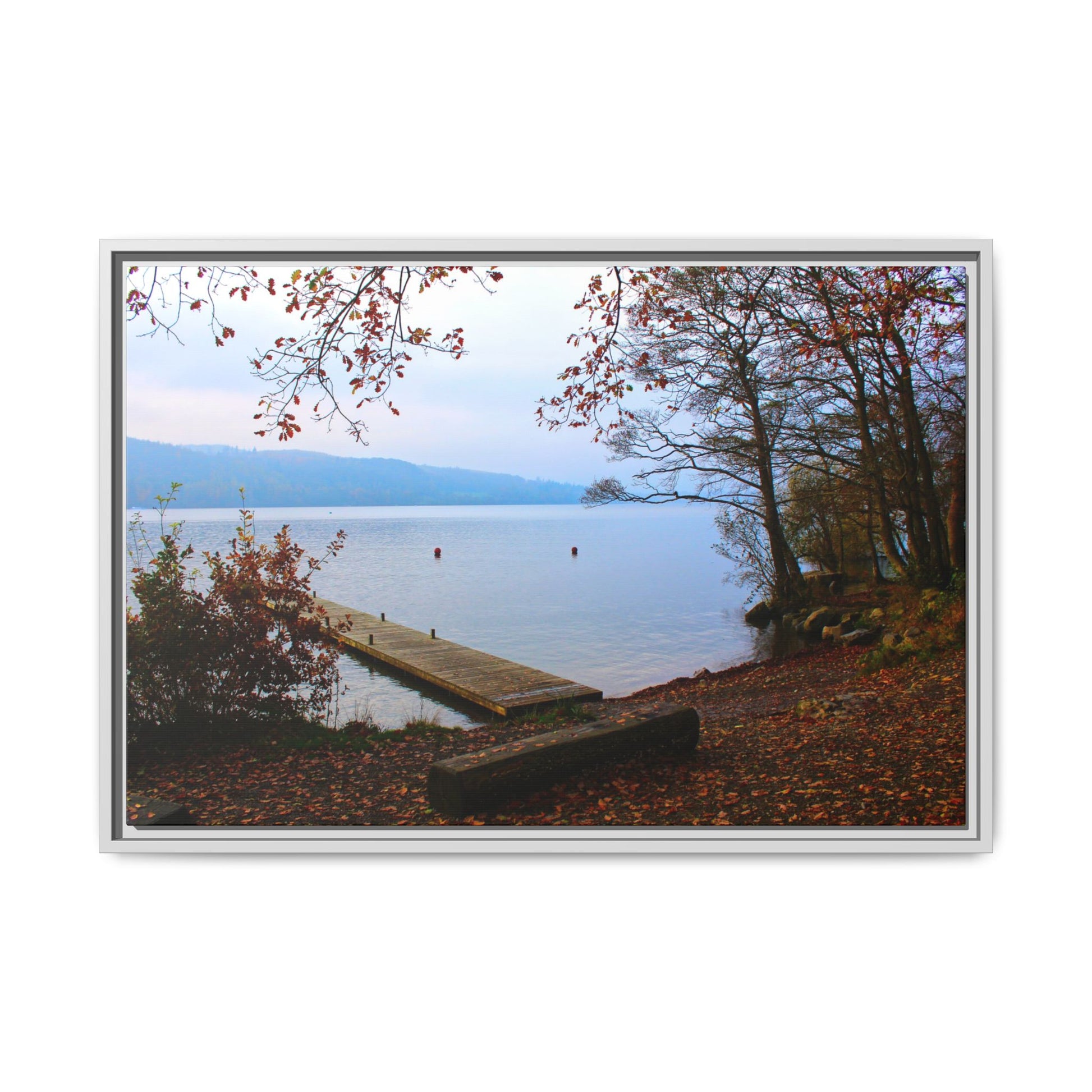 Framed picture of a lake scene with a dock and autumn foliage.