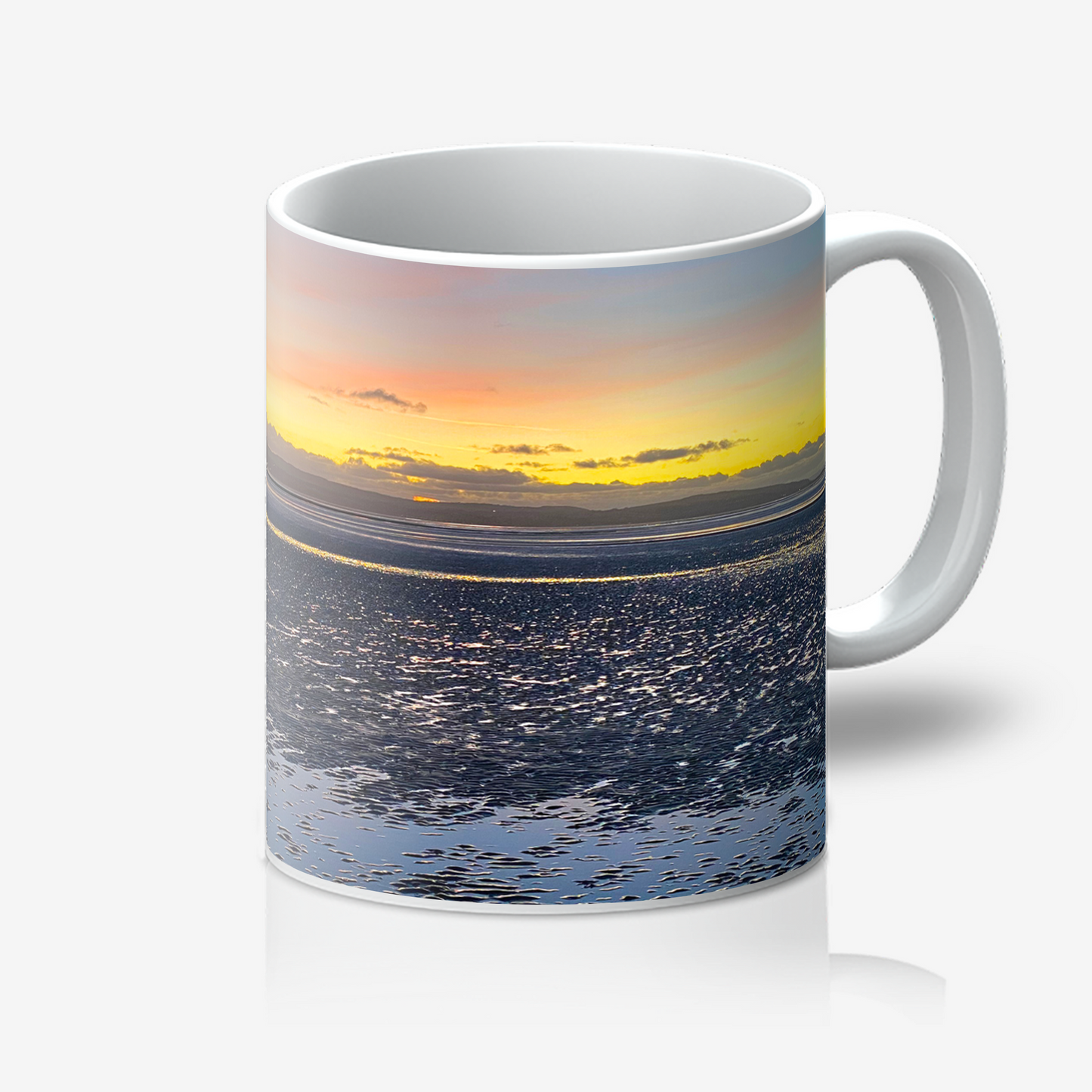 Mug with a sunset over water design on a white background