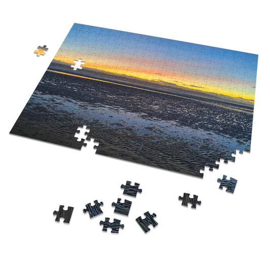 Jigsaw puzzle with a sunset over water scene, some pieces missing.
