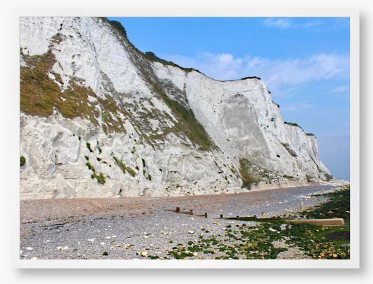 Framed Photo of White cliffs with a pebbly beach and blue sky